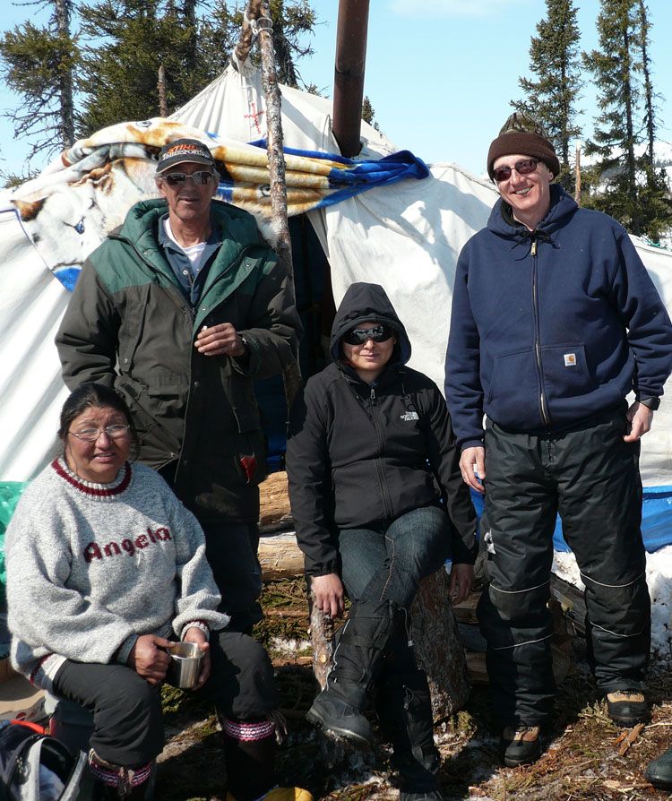 Colin Samson outside tent with group of Innu people