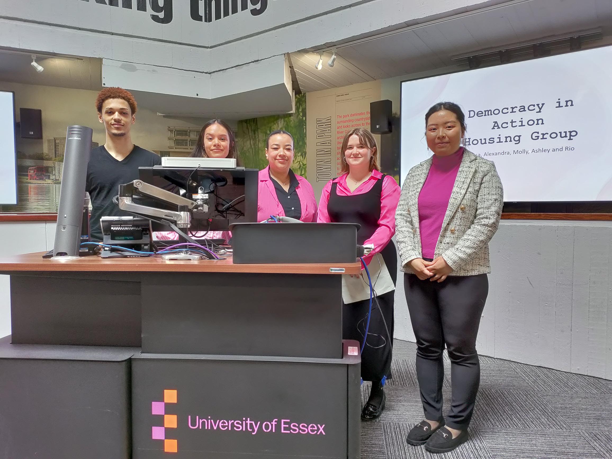 Students presenting behind a computer screen
