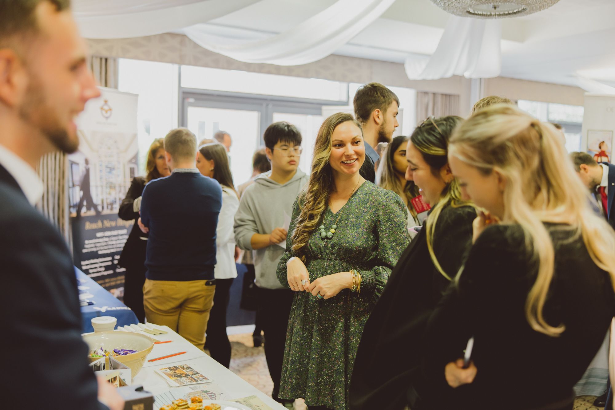 A group of young hospitality professionals chatting at a conference