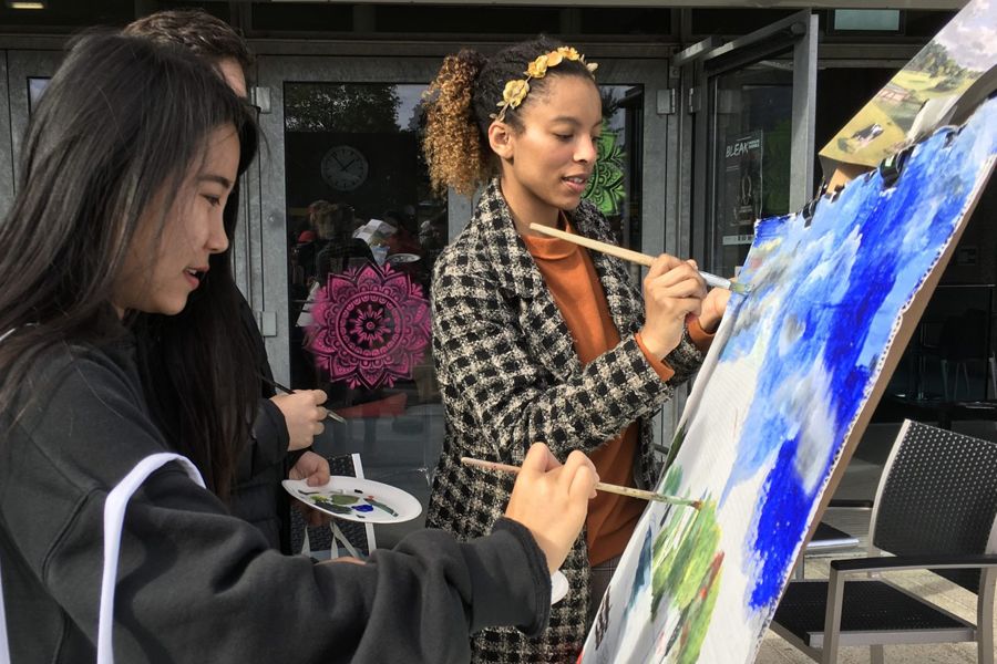 Two students paint their impression of a John Constable artwork outside on our Colchester Campus.