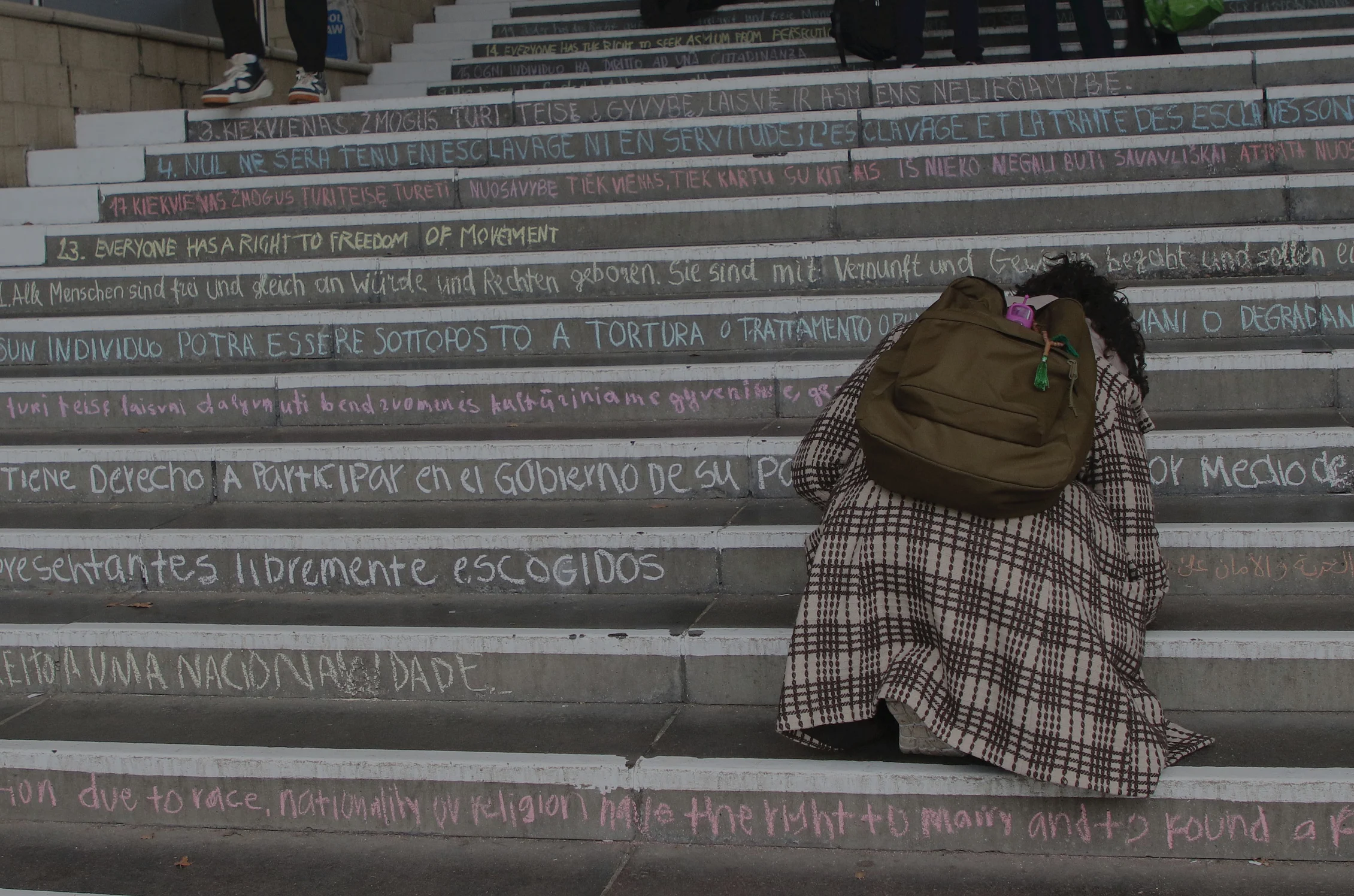 Student writing on the steps at the University of Essex Colchester Campus