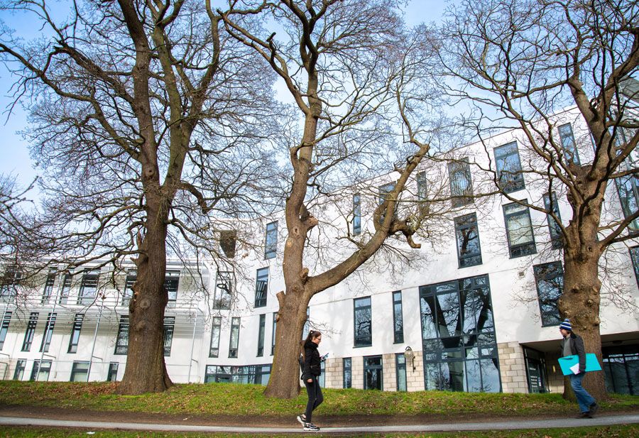 Young woman walking past ISER building