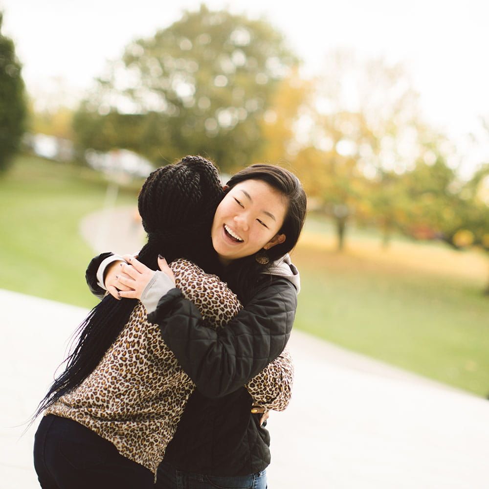Two students hugging