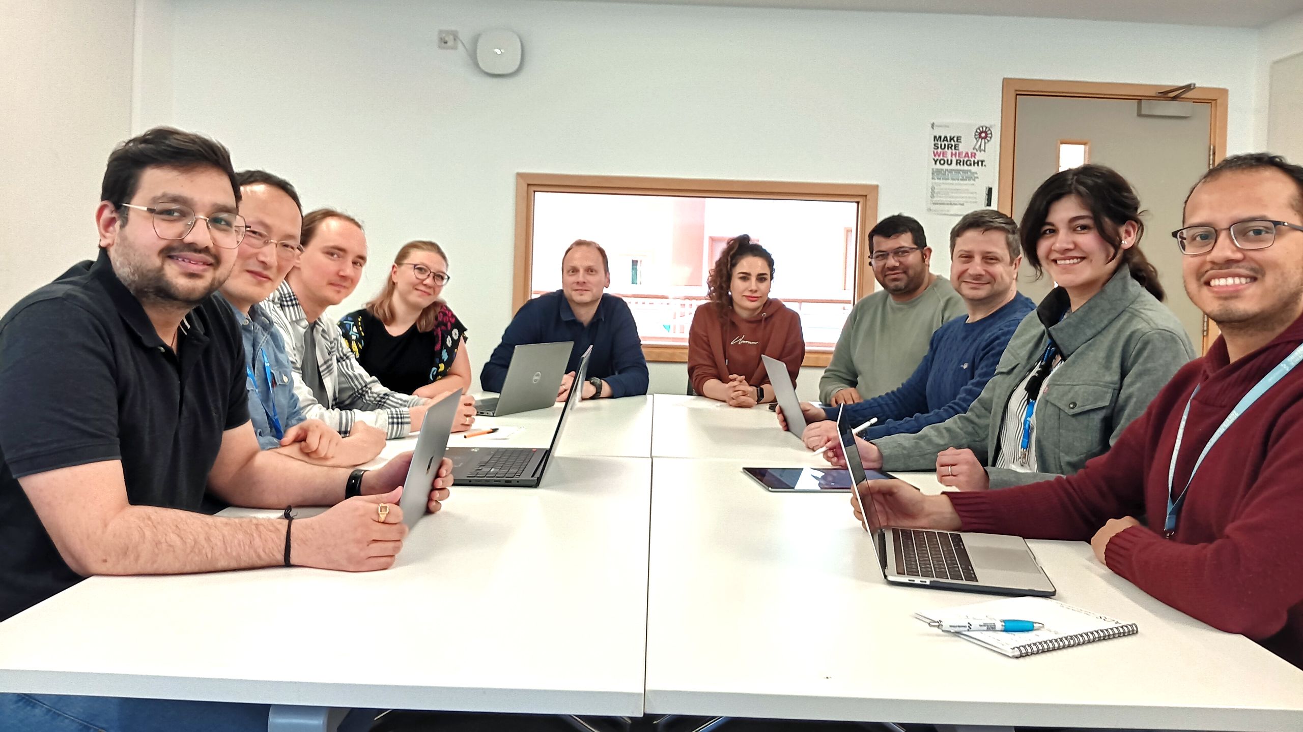 Members of the IADS team sitting around a white table